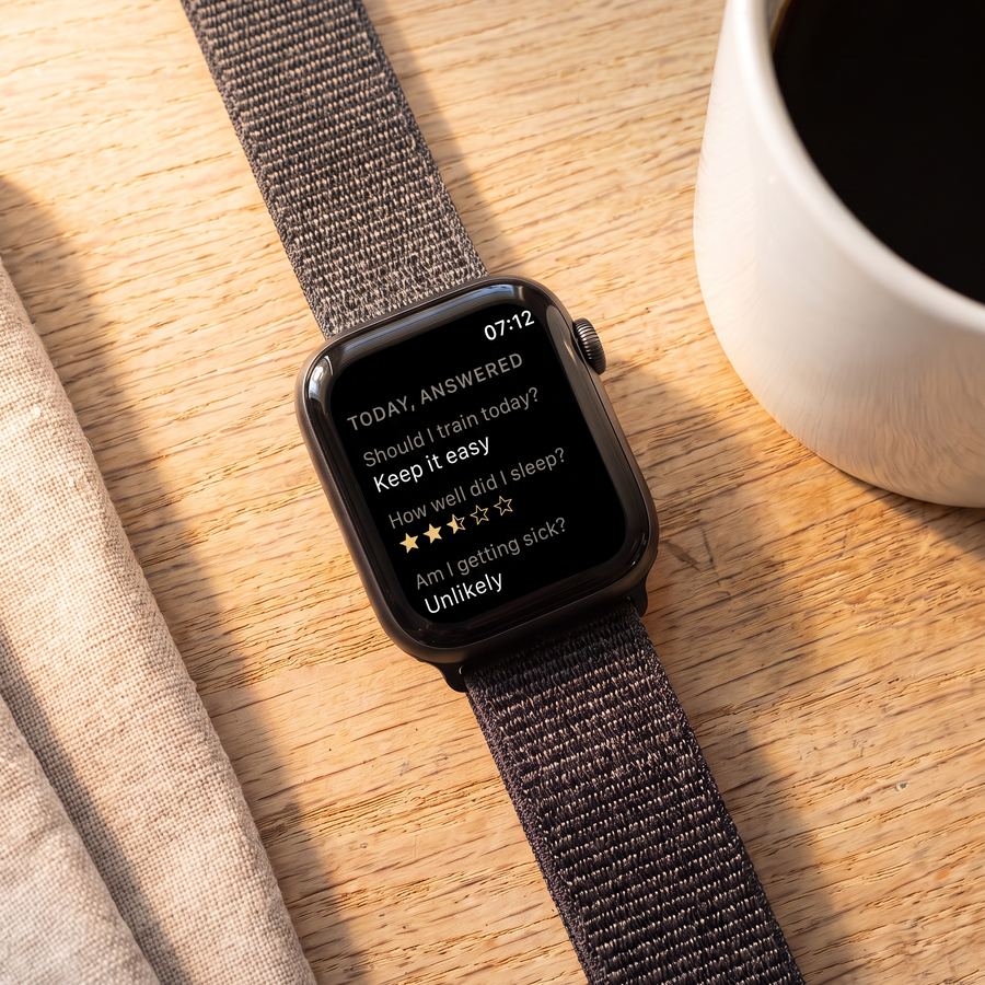 Apple Watch on a wooden table showing Today, answered: keep it easy, two and a half stars, unlikely to be getting sick