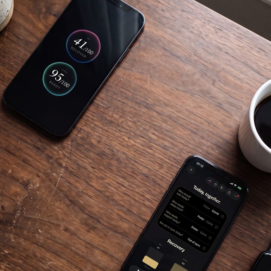 iPhone on a dark wooden table showing two recovery orbs, one at 41 recover and one at 95 ready